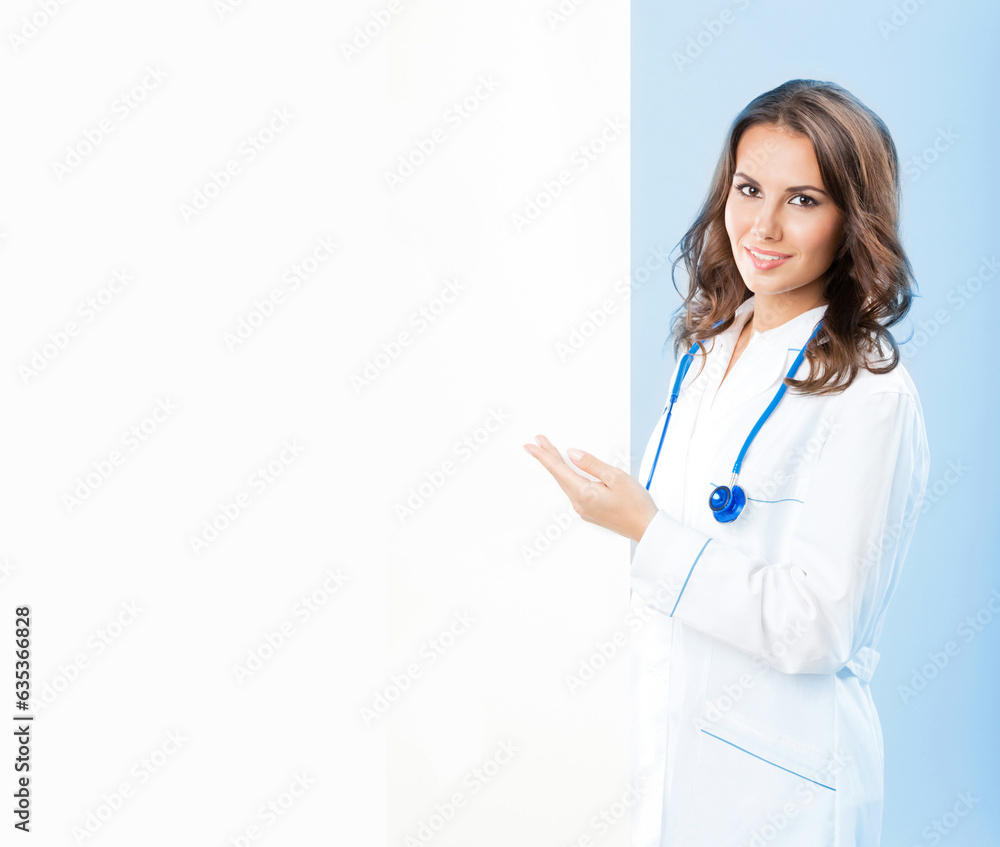 Portrait of happy smiling young female doctor showing blank signboard, isolated over blue background Portrait of happy smiling young female doctor showing blank signboard, isolated over blue background