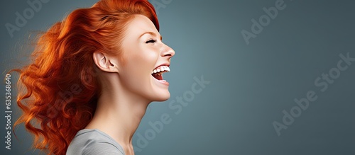 Excited red haired woman screaming and reaching towards empty space