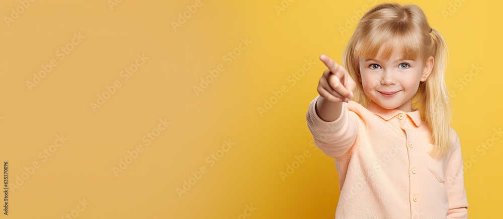 Blonde child pointing at empty space for advertising social media promotion and proposal announcement Blonde child pointing at empty space for advertising social media promotion and proposal announcement