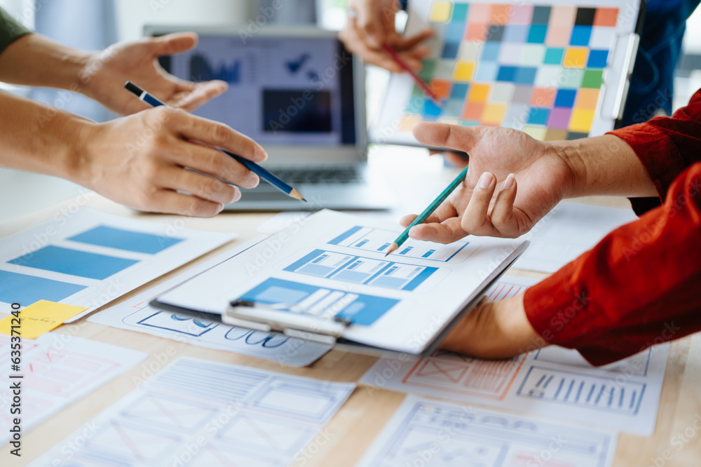 UX developer and ui designer brainstorming about mobile app interface wireframe design with customer breif and color code at office.. UX developer and ui designer brainstorming about mobile app interface wireframe design with customer breif and color code at office..