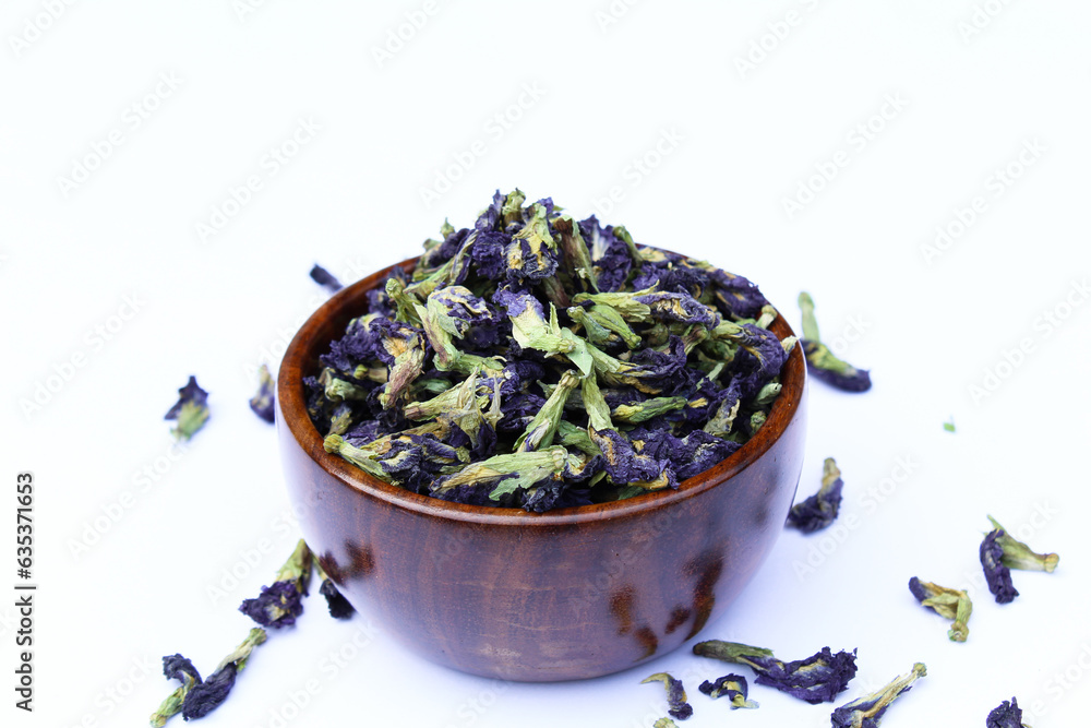 Dried blue butterfly pea flower in a wooden bowl Dried blue butterfly pea flower in a wooden bowl