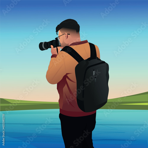 Young man holding camera and taking picture in nature landscape. 