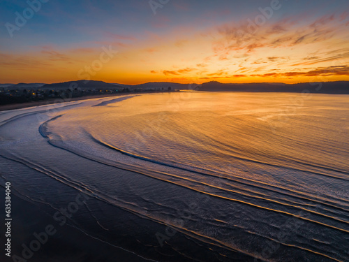 Pretty sunrise at the seaside with high cloud and low tide