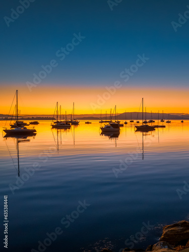 Winter sunrise with clear skies and boats on the water
