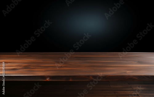 An empty wooden table for presentation with a dark background and isolated recessed lighting