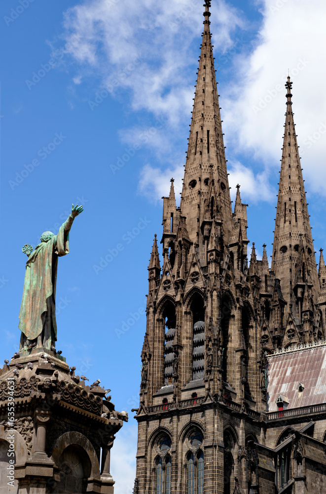Clermont-Ferrand city gothic cathedral Notre-Dame-de-l'Assomption building from black lava and statue of Urban II in France