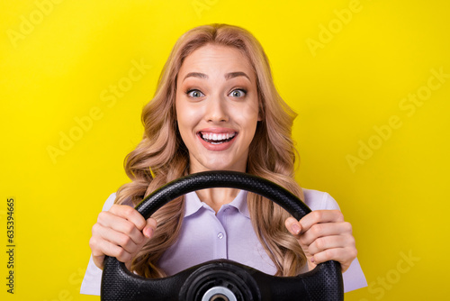 Photo of pretty excited lady wear purple polo enjoying riding car isolated yellow color background