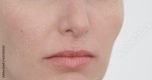 Woman nose inhales air, close up. Caucasian female nostrils breathe on white background. Cropped face portrait. Nose breathing, sniff smell . Healthy breath. European Woman face make inhale, closeup