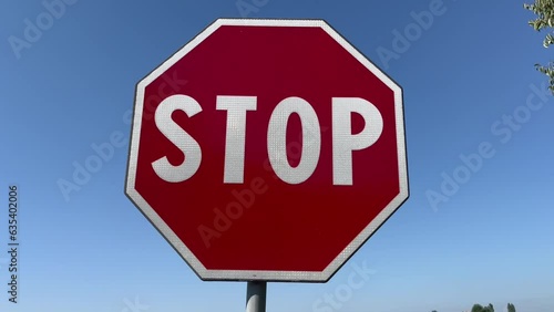 Stop signal in full sun with blue sky. Concept for prohibition, danger, forbidden, depression, protection, bad habits, nostalgia, problem, solitude,advice, control, warning, caution, safety, war, poll