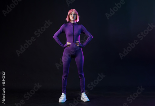 Woman in futuristic costume. Female posing in glasses of virtual reality. Augmented reality game, future technology, AI concept. VR. Neon blue and red light. Dark background. © KDdesignphoto