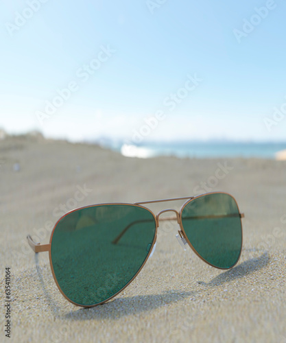 Close up of sunglasses on a beautiful beach with the ocean in the background relaxing on holiday 3d render