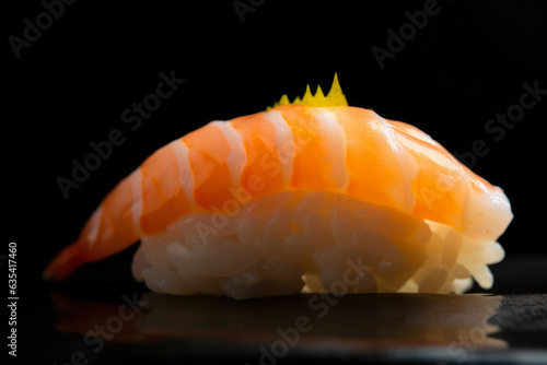 Shrimp nigiri sushi with a slice of lemon on top, a mouthwatering macro shot.