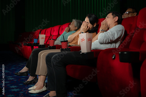 Фотография When watching scary ghost movies in theaters, moviegoers appear terrified