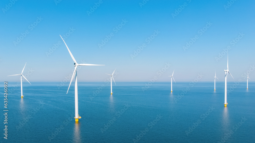 Ocean Wind Farm. Windmill farm in the ocean. Offshore wind turbines in the sea. Wind turbine from aerial view