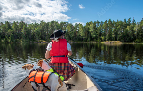 Woman canoeing with dog on the lake