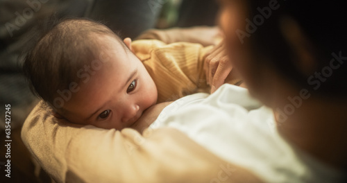 High Angle Portrait of a Cute Asian Baby Feeding from the Breast of Her Mother. Intimate Moment Between New Mother and Infant Showing Motherly Love, Tenderness and Unconditional Affection