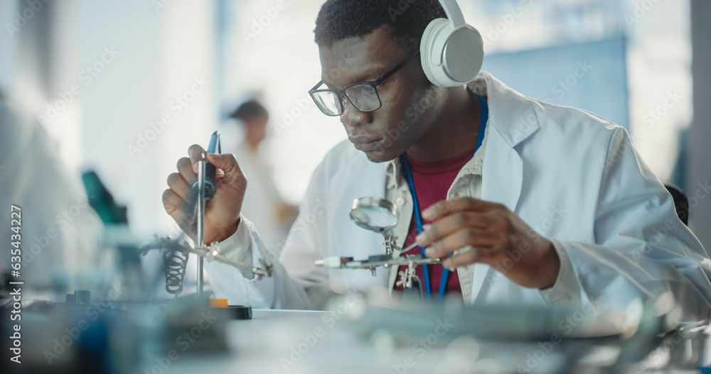 Portrait of Black Male Lab Specialist Soldering a Circuit Board, Using ...