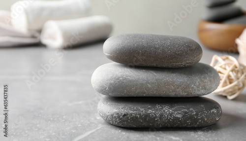 Beautiful composition with spa stones on grey marble table  closeup. Space for text