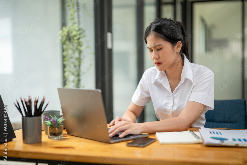 Stressed businesswoman working from laptop, project documentation error, Notify news of damage by email Stressed businesswoman working from laptop, project documentation error, Notify news of damage by email