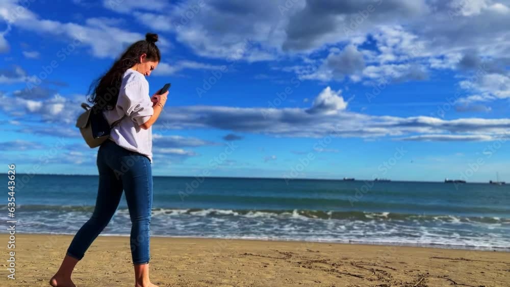 Beautiful women looking at the sea in Alicante, Spain during the day Beautiful women looking at the sea in Alicante, Spain during the day