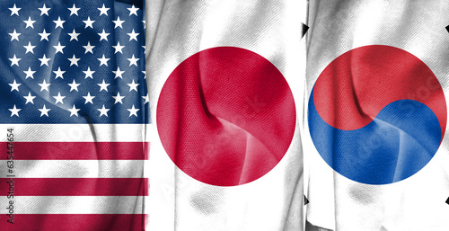 Double exposure concept image of American flag combined with Japanese and South Korean flags and cloth texture. Describe the summits of the leaders of the United States, Japan, and South Korea. photo