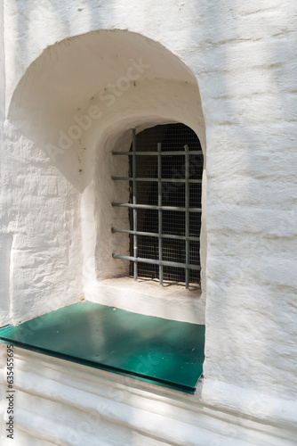 Yaroslavl  Russia  July 4  2023. A window with bars in the thick wall of an old church.