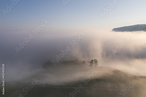 Summer aerial landscape above the foggy valley © alexionutcoman