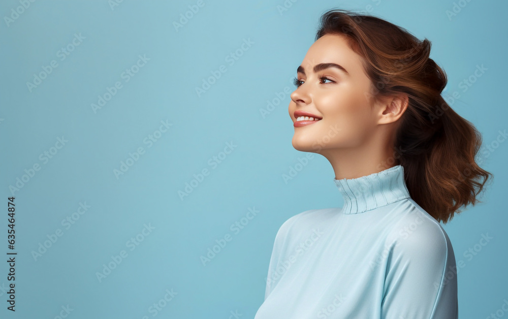 Dreamy and pensive looking young woman in profile portrait - isolated on light blue background Dreamy and pensive looking young woman in profile portrait - isolated on light blue background