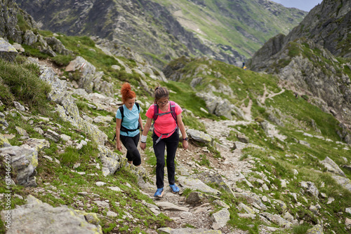 Women hiking on a trail in the rocky mountains