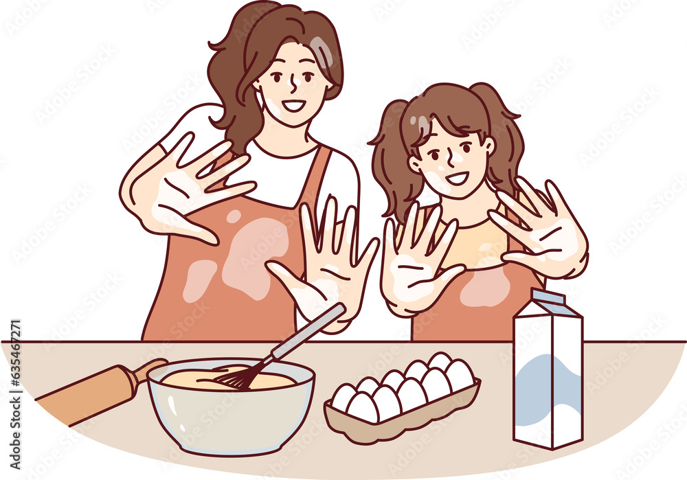 Mom and daughter are preparing breakfast or pastries and with smile show palms stained with flour Mom and daughter are preparing breakfast or pastries and with smile show palms stained with flour