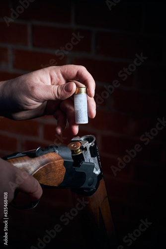 a man slaughters a shotgun with ammunition 