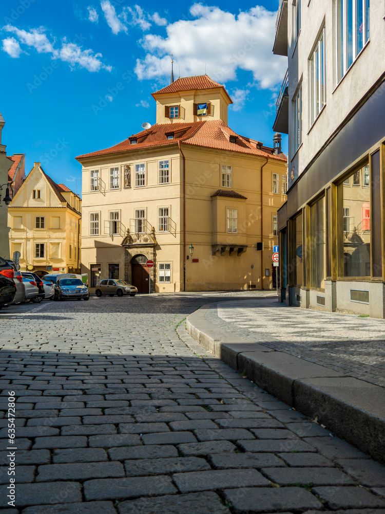 Fototapeta premium Cobblestone street and typical house in old town of Prague.