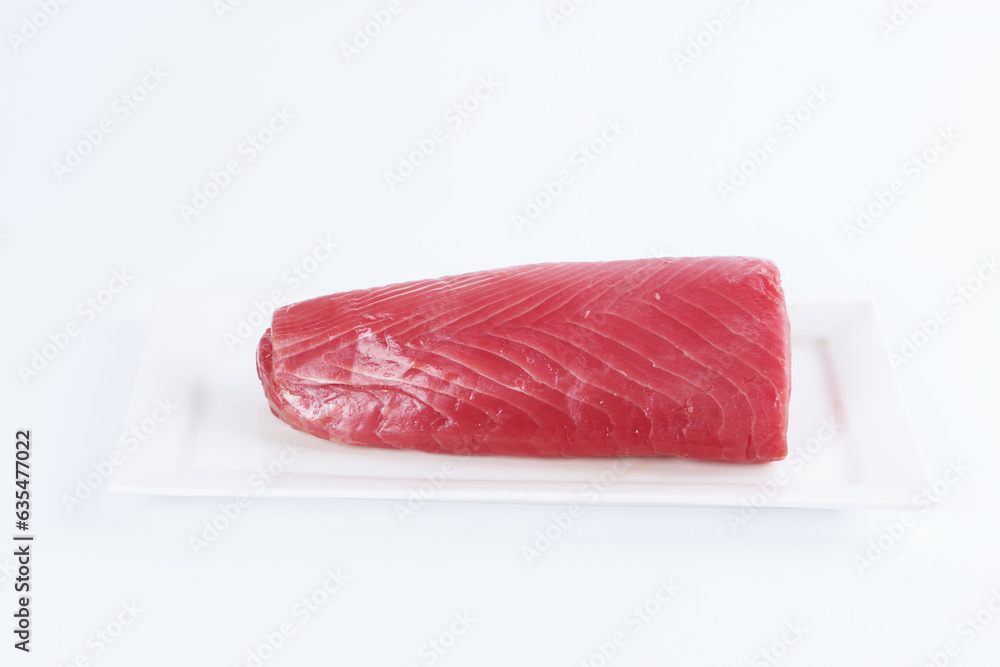 Fresh tuna on a white background. A piece of tuna on a platter. Healthy food. natural omega.Isolated object.Copy space.