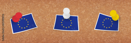 European Union flag pinned in cork board, three versions of European Union flag.