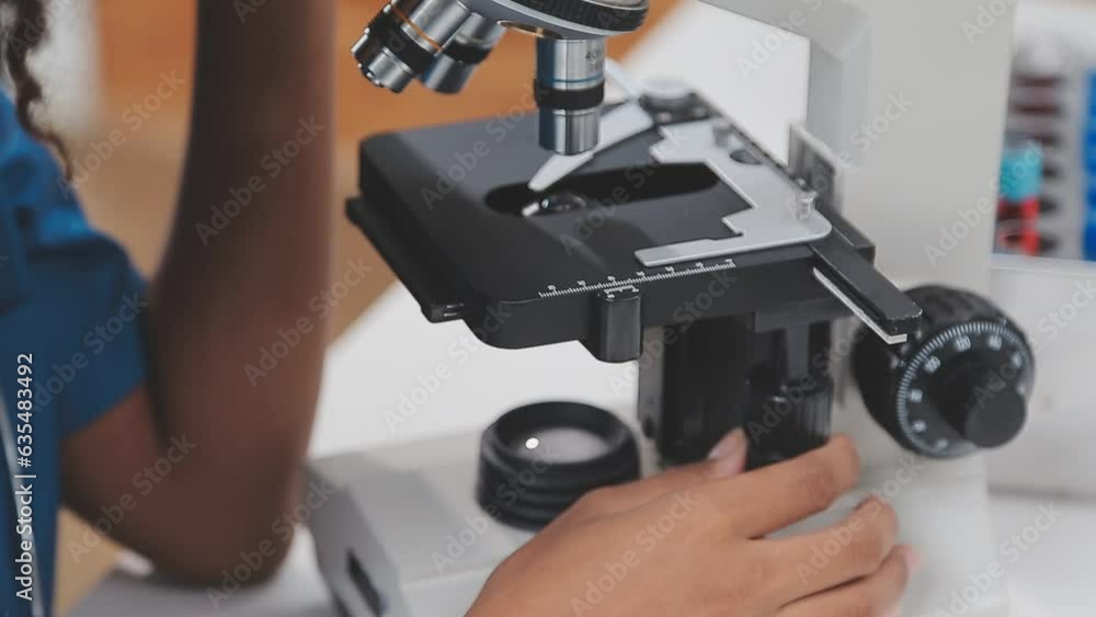 Health care researchers working in life science laboratory. Young female research scientist and senior male supervisor preparing and analyzing microscope slides in research lab. Health care researchers working in life science laboratory. Young female research scientist and senior male supervisor preparing and analyzing microscope slides in research lab.