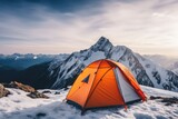Orange travel  tent at dawn in the mountains, hiking topic. Winter adventures. Ski resort 