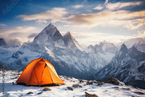 Orange travel tent or camp in the winter mountains. Great view of snow and lake, beautiful view . Dramatic and picturesque scene.