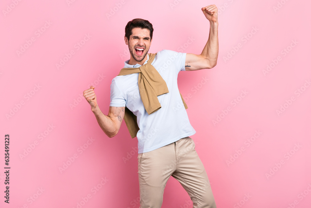 Photo of satisfied ecstatic man raise fists celebrate accomplishment triumph isolated on pink color background Photo of satisfied ecstatic man raise fists celebrate accomplishment triumph isolated on pink color background