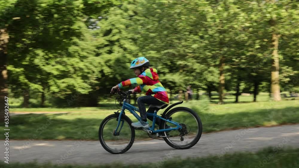 Happy kid boy, having fun in park with a bicycle on beautiful day. Active child Happy kid boy, having fun in park with a bicycle on beautiful day. Active child