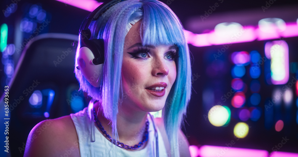 Close Up Portrait of a Beautiful Young Female Wearing Headphones, Talking with Friends Online on a Computer. Popular Cosplay Streamer Chatting with Internet Fans. Gamer Girl Playing Video Games Close Up Portrait of a Beautiful Young Female Wearing Headphones, Talking with Friends Online on a Computer. Popular Cosplay Streamer Chatting with Internet Fans. Gamer Girl Playing Video Games