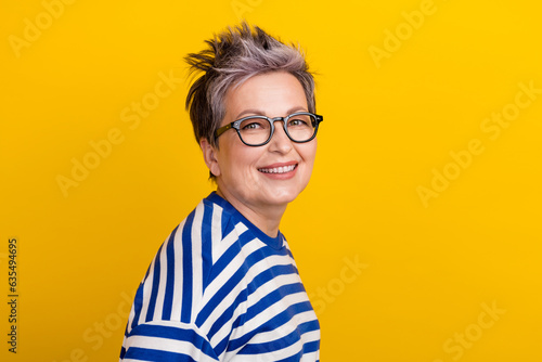 Portrait of young beautiful businesswoman striped blue pullover dyed short haircut lady posing magazine isolated on yellow color background