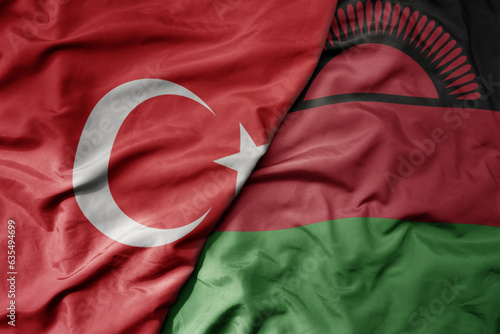 big waving national colorful flag of turkey and national flag of malawi .