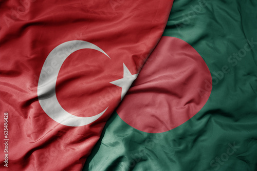big waving national colorful flag of turkey and national flag of bangladesh .