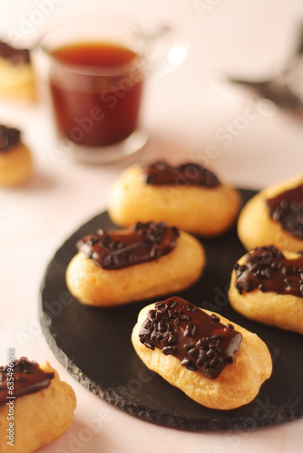 Traditional French dessert - eclairs with a cup of coffee