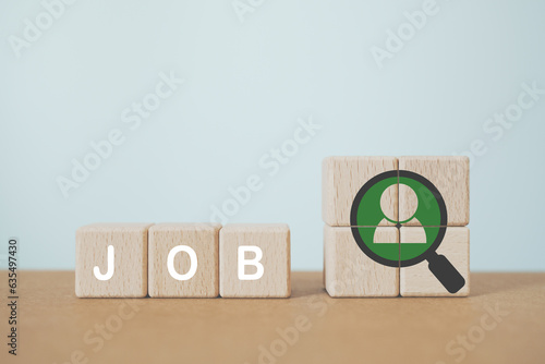 man inside magnifying glass with job word on wooden cube blocks. Human resource, promotion, career, probation, hiring concept