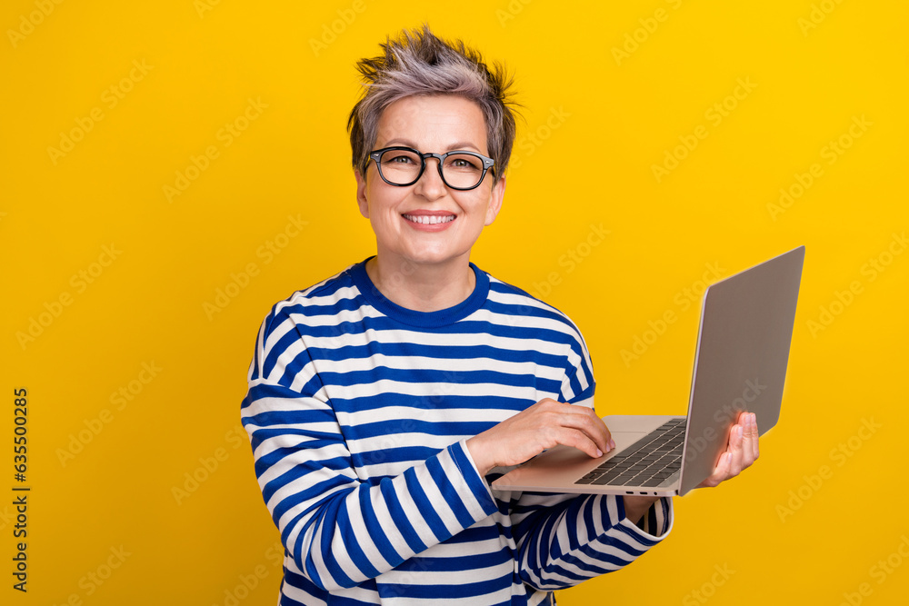 Photo of it specialist businesswoman holding modern laptop professional realtor working remote job isolated on yellow color background Photo of it specialist businesswoman holding modern laptop professional realtor working remote job isolated on yellow color background