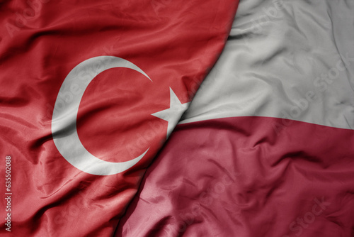 big waving national colorful flag of turkey and national flag of poland .
