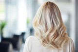 Blonde woman showing her beautiful long hair after a professional hair cut