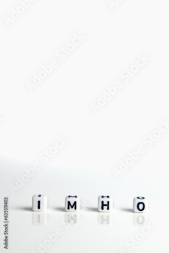 imho word or concept made by white letter cubes on white and gray background, in my honest humble opinion abbreviation