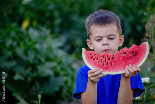 A child eats a watermelon. Selective focus.